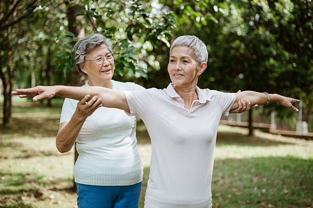 Person practicing gentle tai chi movements outdoors